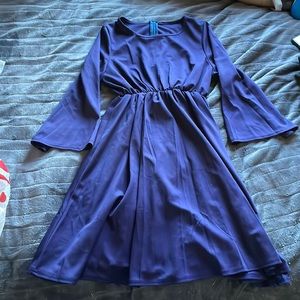 Purple dress with zipper and curved neckline.
